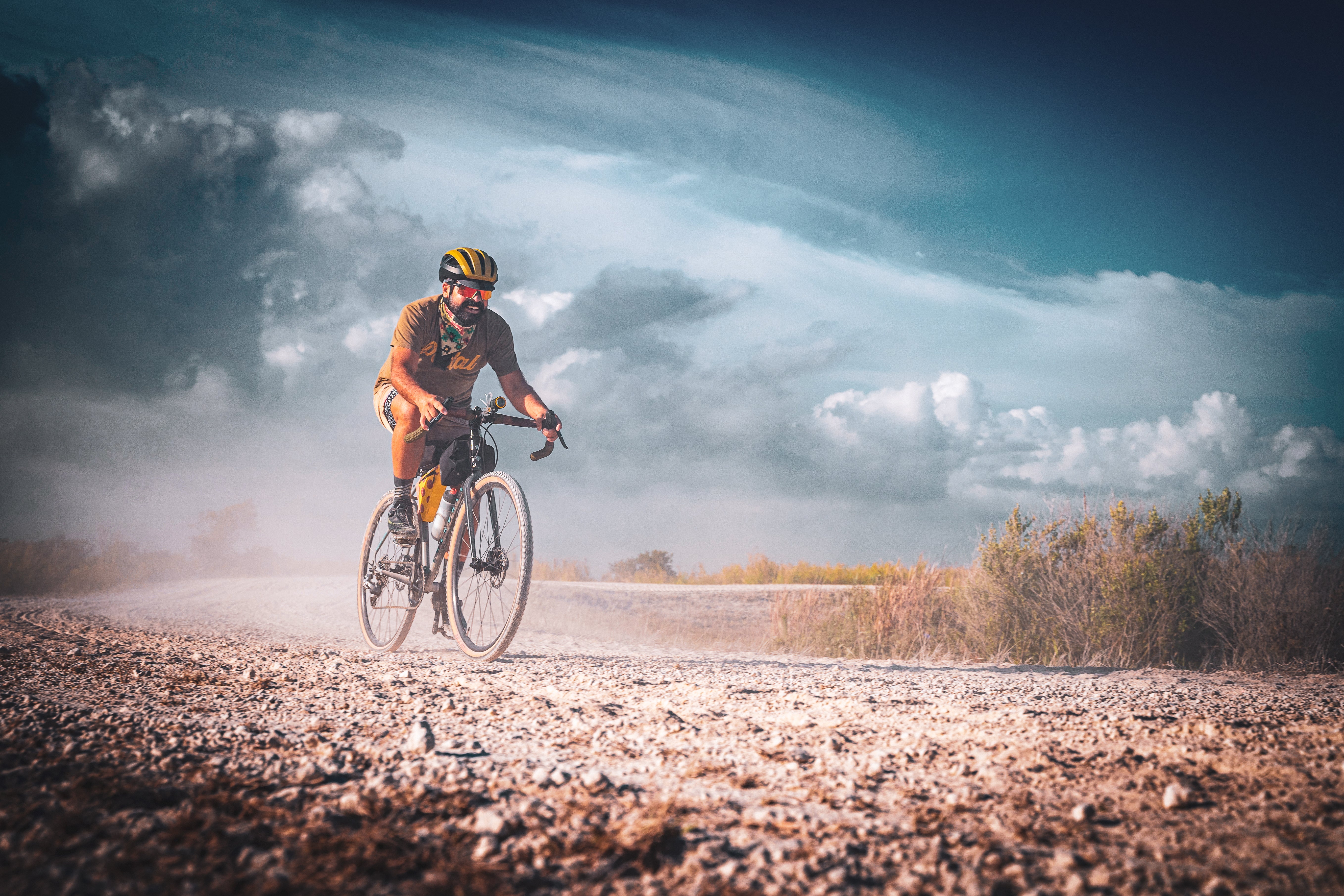 Two riders cycling through tall grass in the Everglades